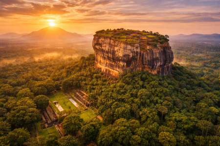 Sigiriya Lion Rock fortress at sunrise surrounded by jungle in Sri Lanka