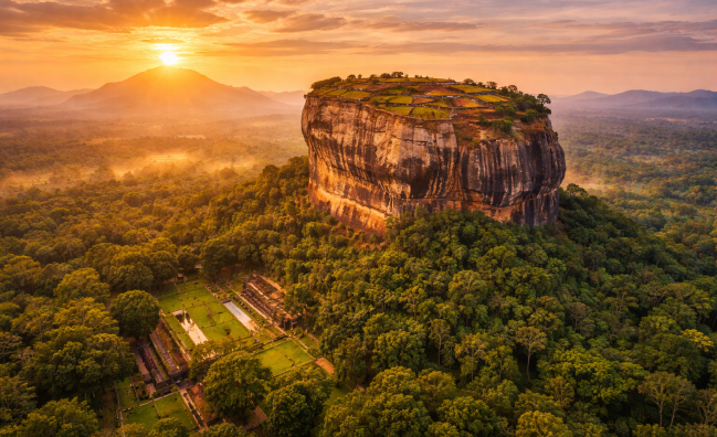 Sigiriya Lion Rock fortress at sunrise surrounded by jungle in Sri Lanka